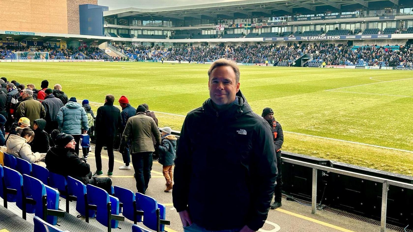 Andrew Smith in the stands at AFC Wimbledon's Cherry Red Records Stadium