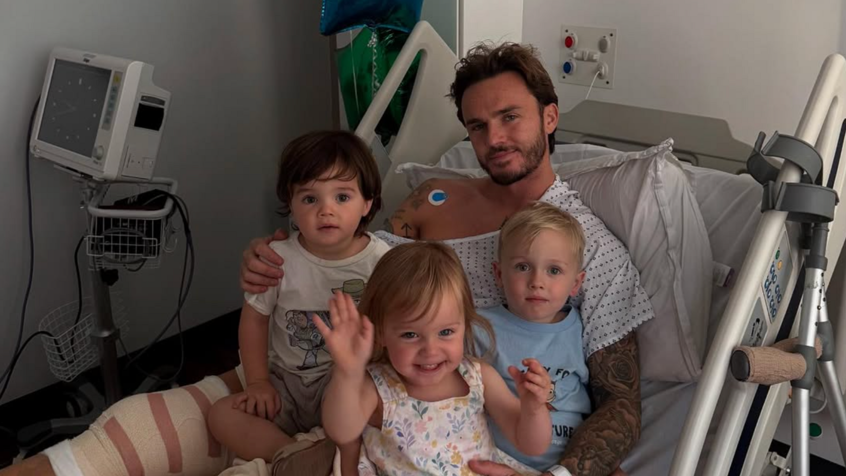 James Maddison poses for a photograph with his three children while in hospital