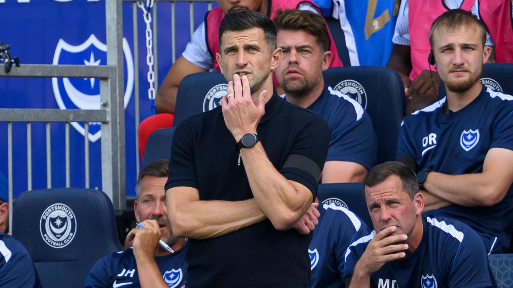John Mousinho looks on from the touchline at Fratton Park