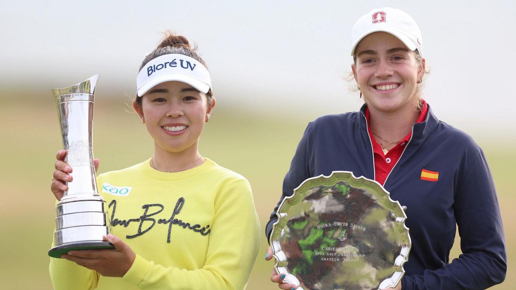 Miyu Yamashita, the winner, and leading amateur Paula Martin Sampedro pose with their trophies on day four of the 2025 AIG Women's Open at Royal Porthcawl