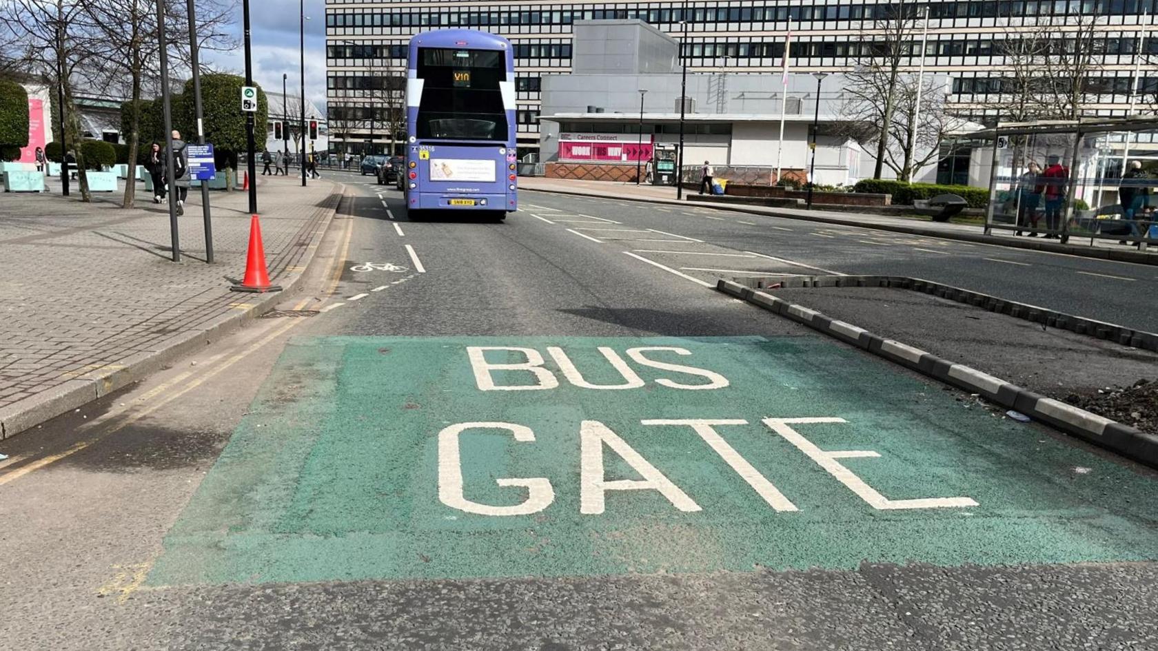 Double decker bus on a green marked area of road