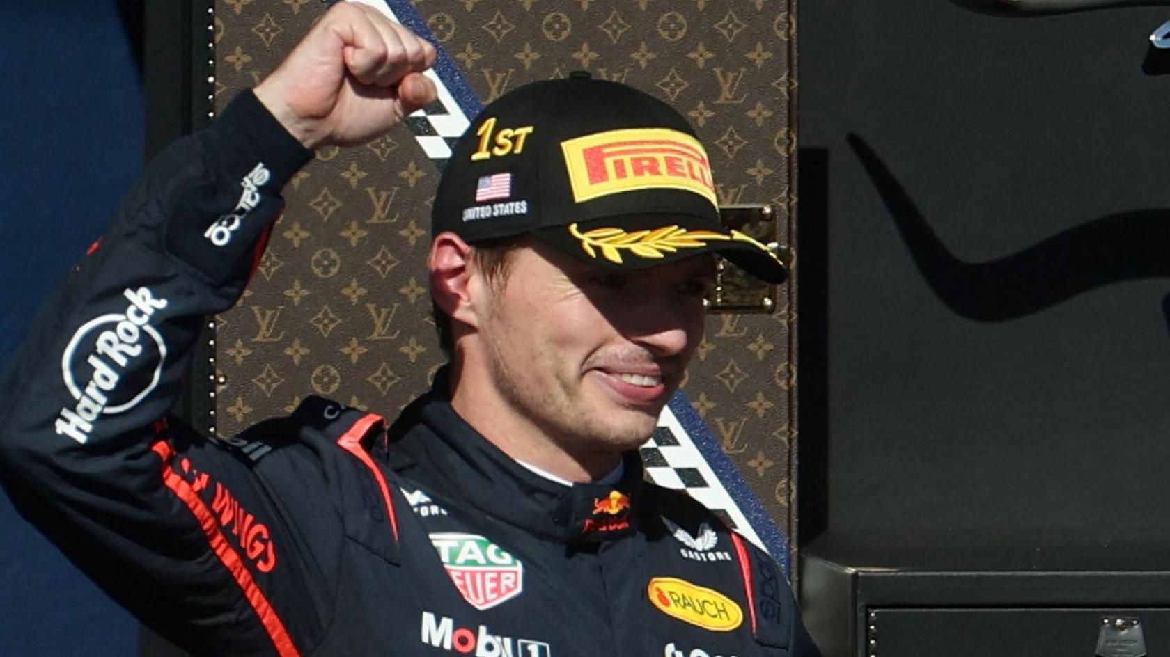 Red Bull's lifts his right arm in celebration after winning the United States Grand Prix