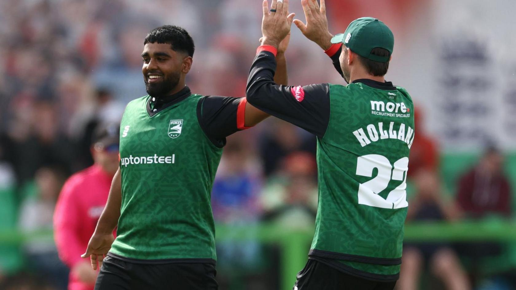 Rehan Ahmed celebrates with Ian Holland after taking a wicket against Yorkshire