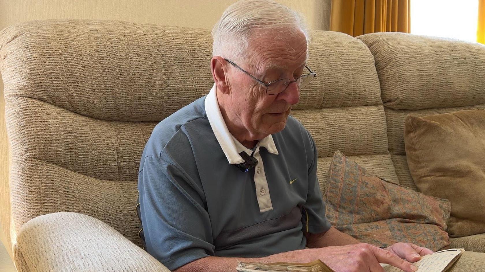 Peter Herke holds the photo album his mother put together as he was growing up in German occupied Poland.