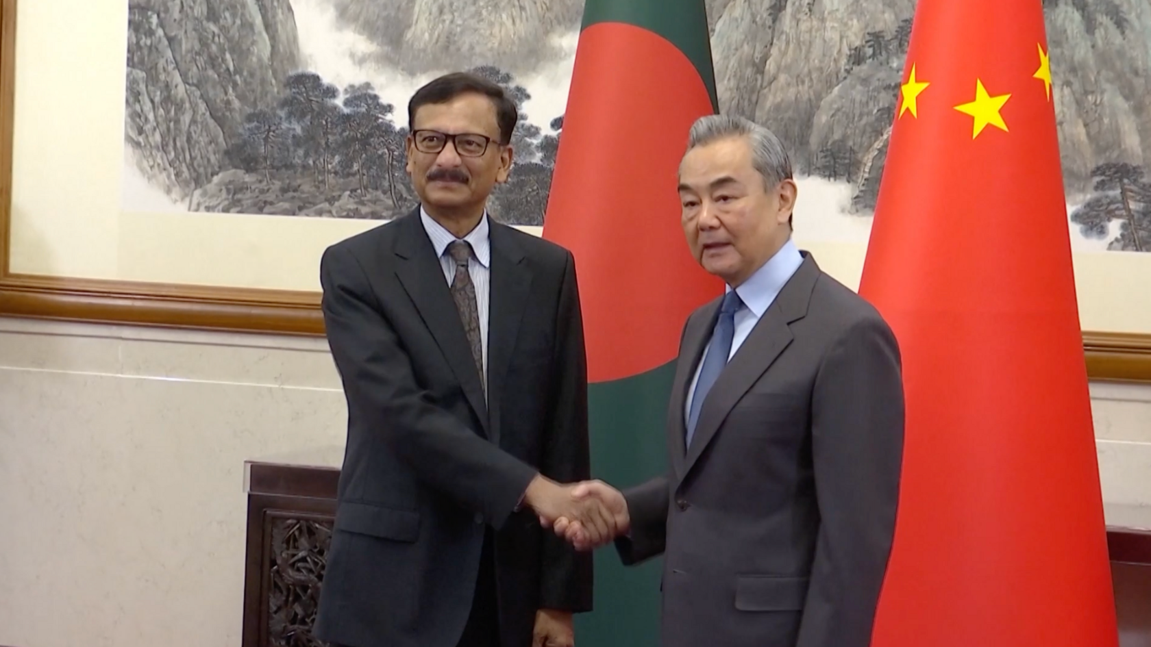 Chinese Foreign Minister Wang Yi shakes hands and meets with Adviser for Foreign Affairs of the Interim Government of Bangladesh Touhid Hossain, attendees on January 21, 2025 in Beijing, China.