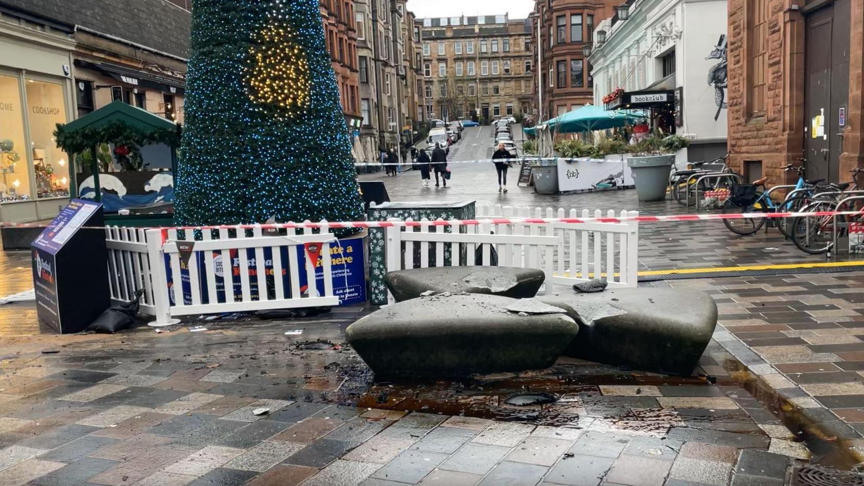 A granite-like seating area next to a Christmas tree on a pedestrianised zone in the west end of Glasgow