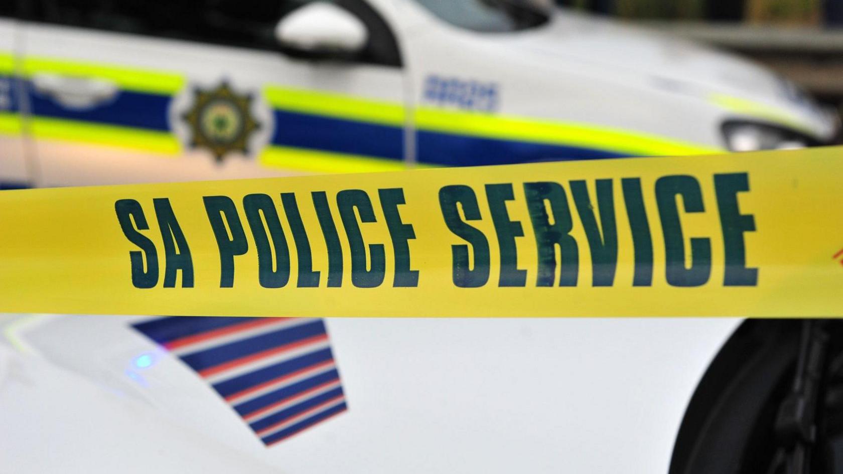 A stock image of a police car with police tape in front of it which reads 'SA police service