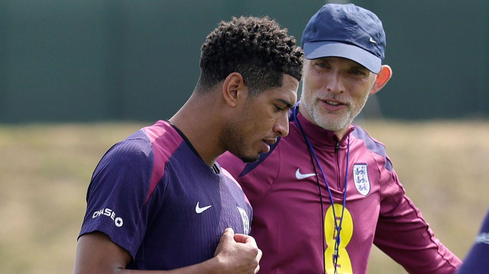 Thomas Tuchel, Head Coach of England, talks to Jude Bellingham