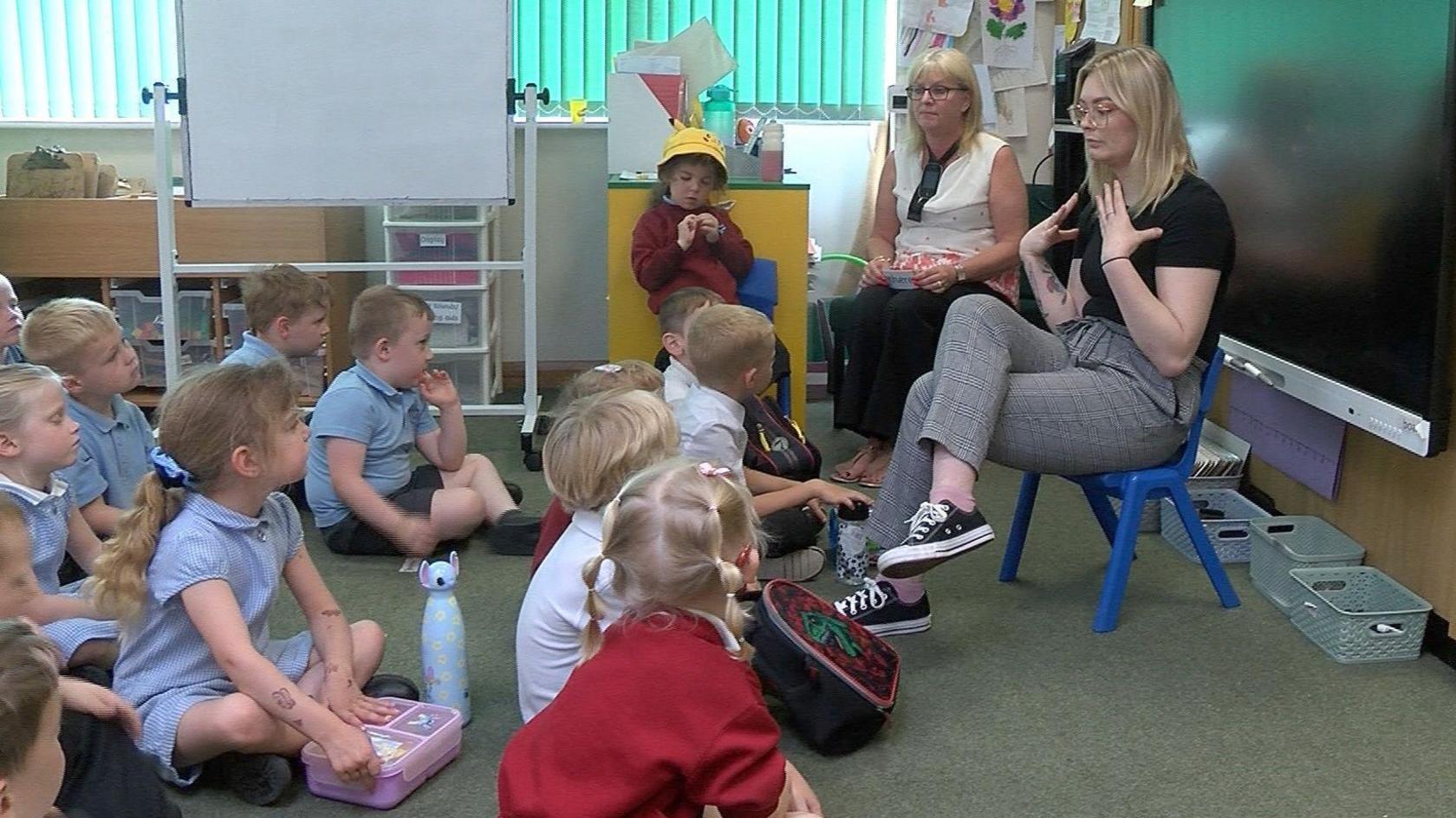 Children in a classroom learning sign language