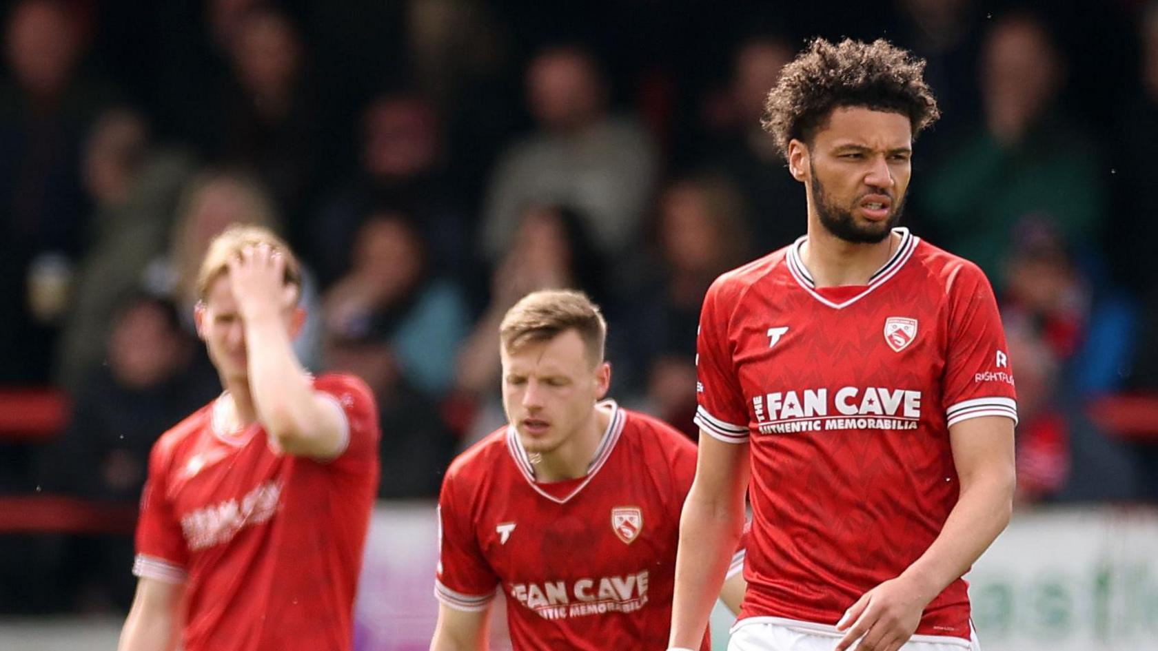 Morecambe look dejected after Salford City score