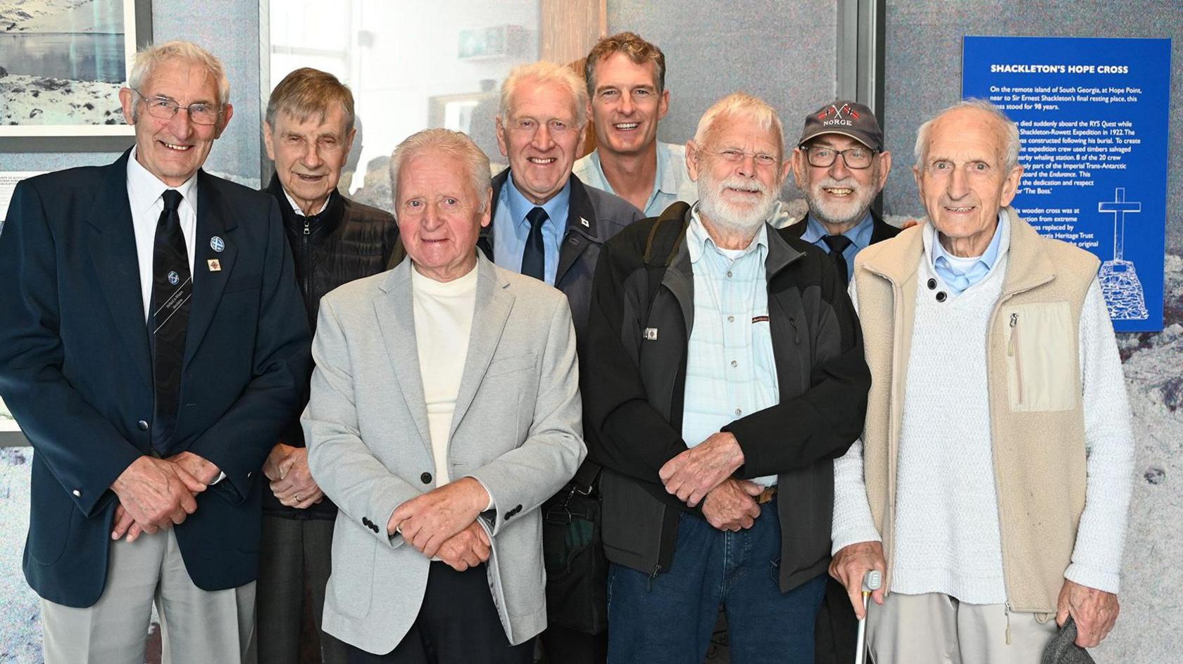 Dan Snow, back, with a group of former whalers all smiling at the camera.