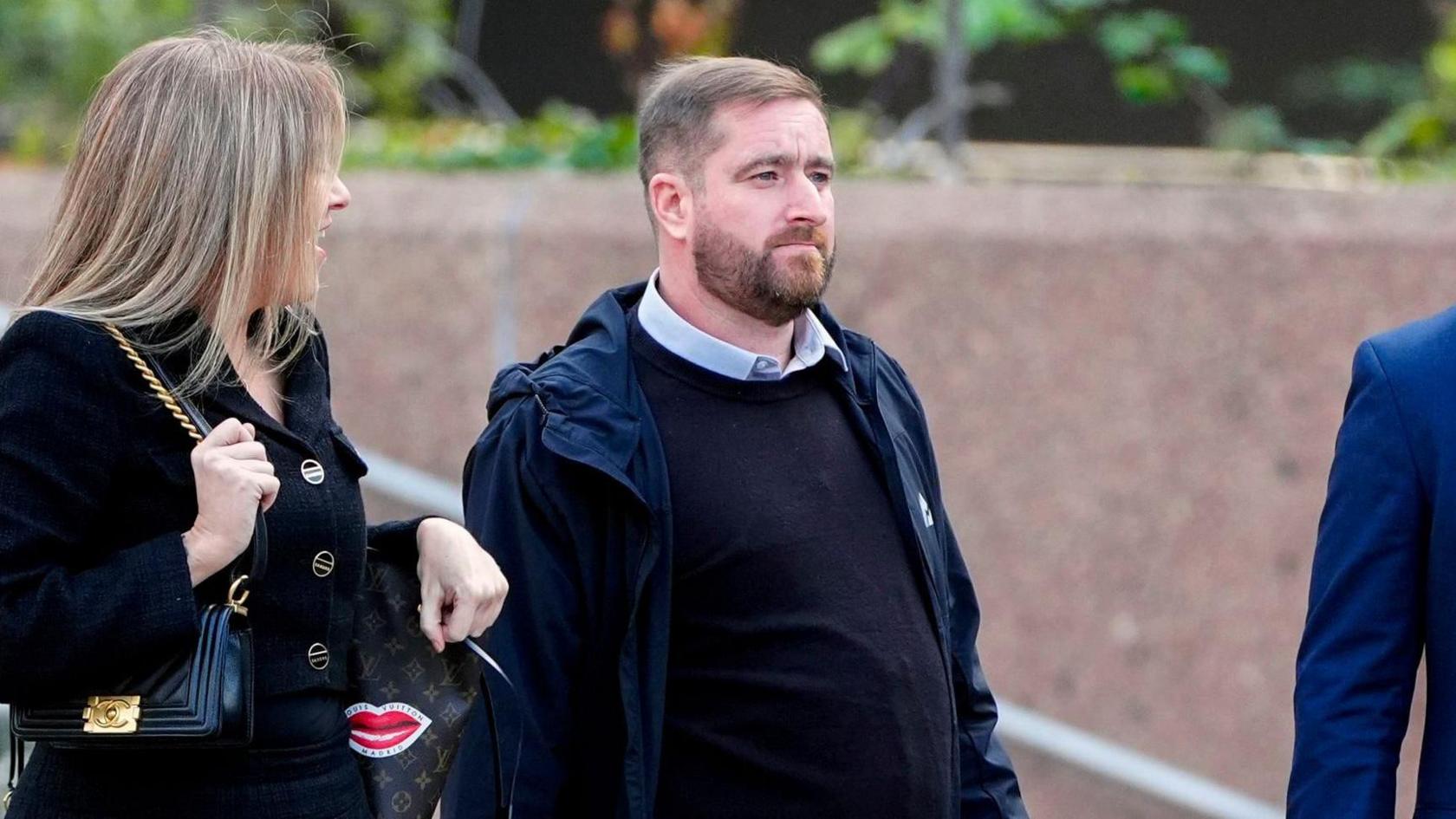 David Chambers,  who has brown hair swept to one side and a short brown beard, leaving Liverpool Crown Court