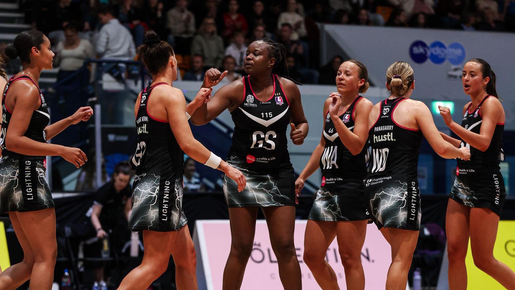 A group of five Loughborough Lightning players congratulate each other 