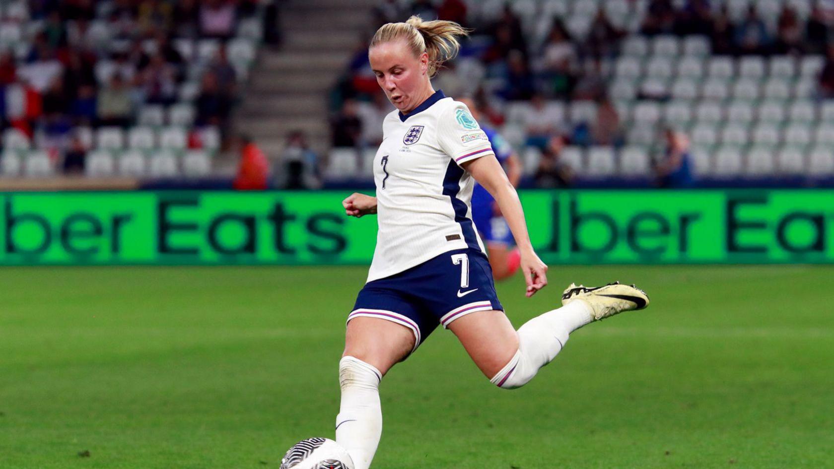 Beth Mead in England kit kicking a ball during a game