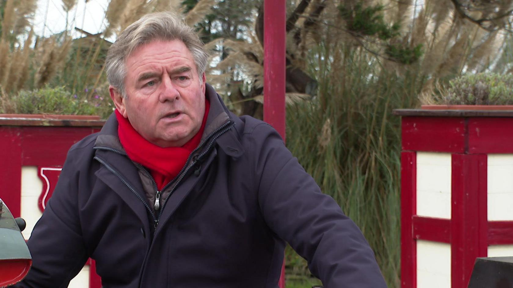 Norman Wallis sitting on a miniature train