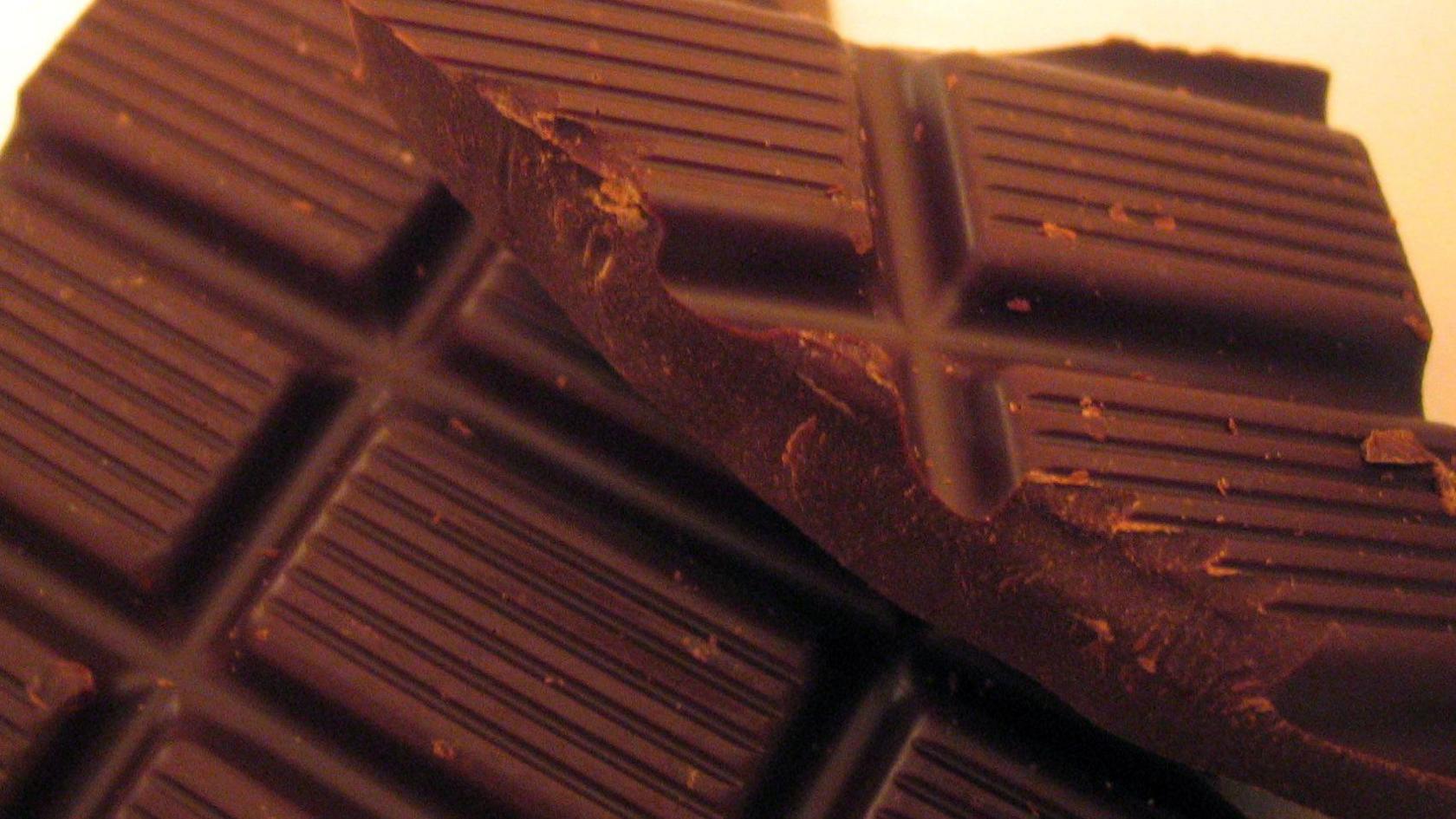 Unwrapped bars of chocolate stacked on top of each other.