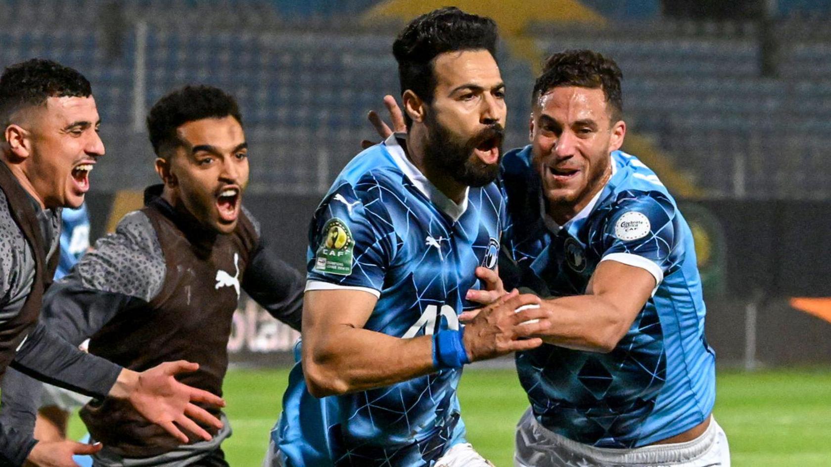 Pyramids player Ahmed Samy (second right) peels away in celebration after scoring a goal against Mamelodi Sundowns as two substitutes and a team-mate try and catch up with him
