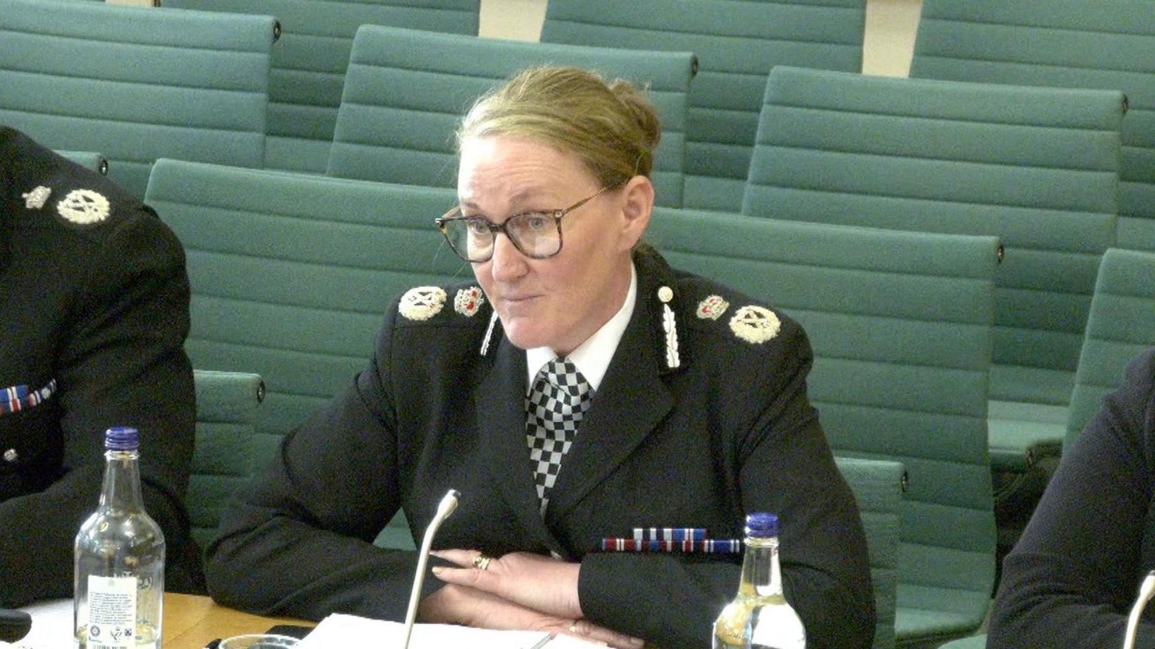 Merseyside Chief Constable Serena Kennedy, who has glasses and blonde hair in tied a bun, speaks to MPs. She is wearing her black police uniform.