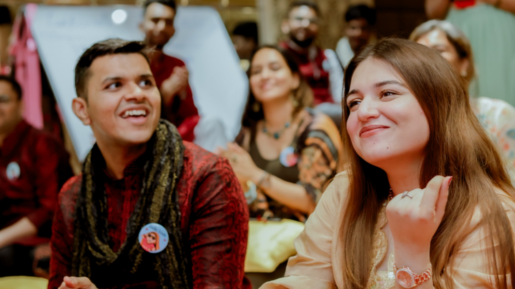 A man and a woman sitting at a fake wedding celebration