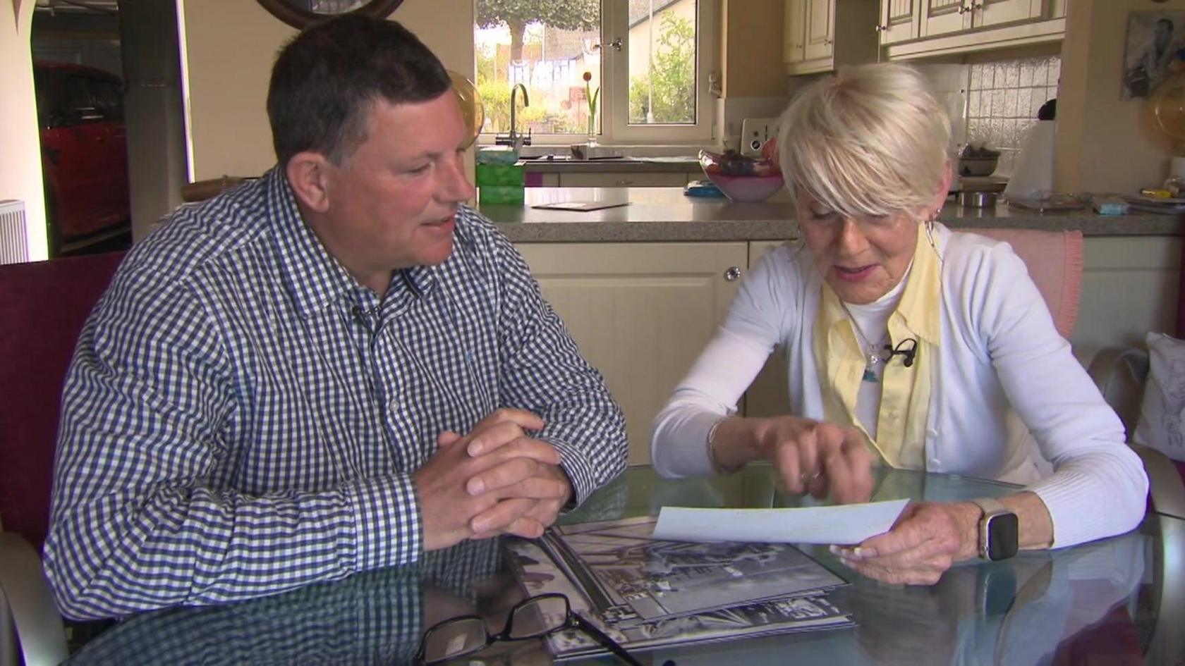 Andrew Price and Gina Campbell look over photographs