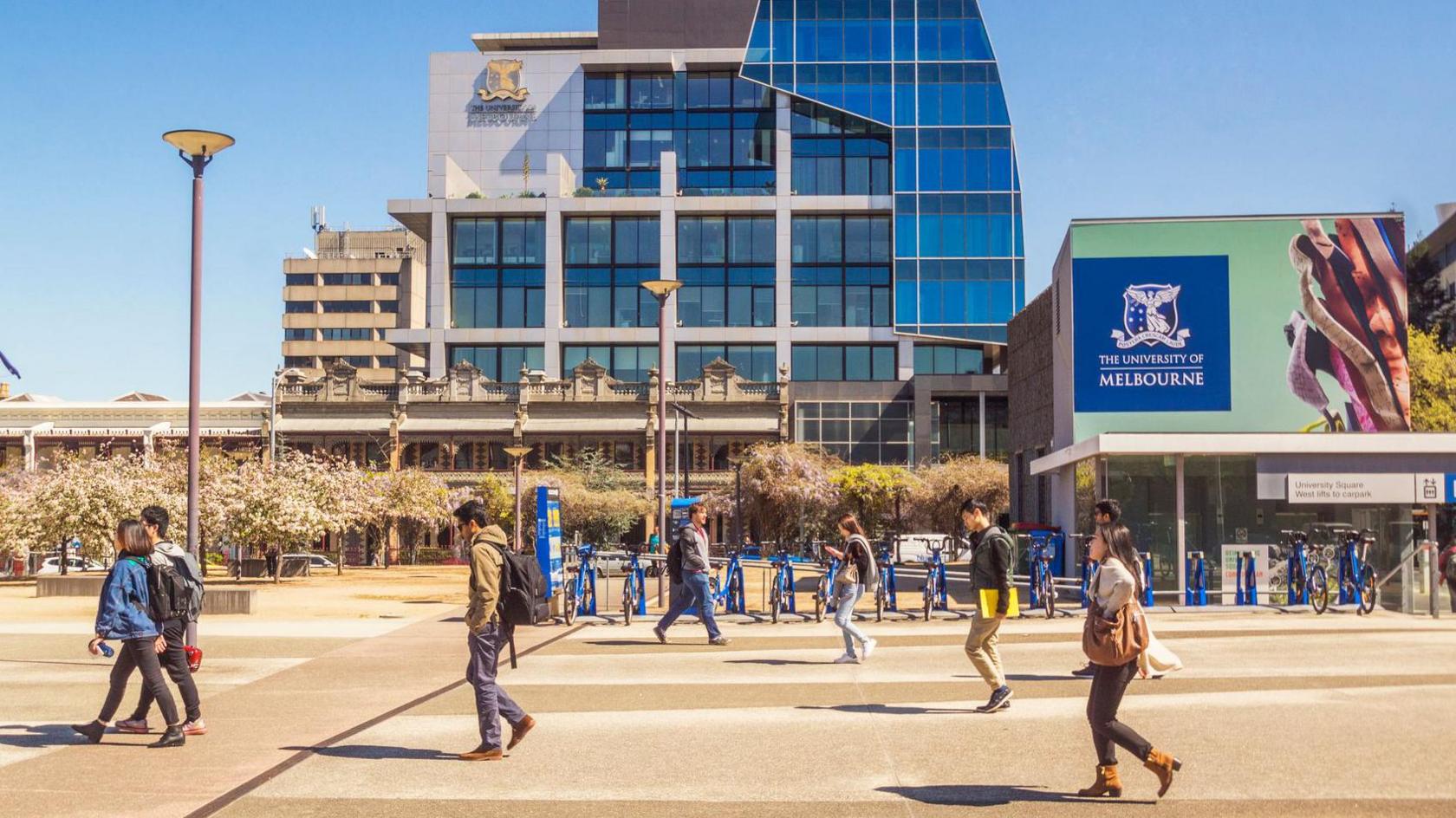 People walk in front of University of Melbourne buildings