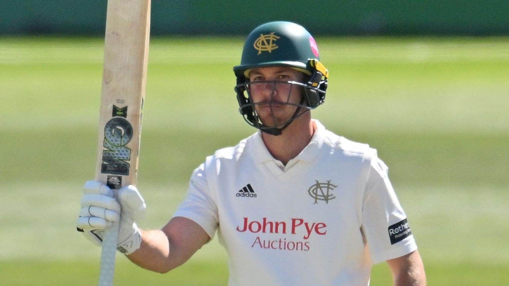 Batter Matt Montgomery raises his bat in his right hand while playing for Nottinghamshire