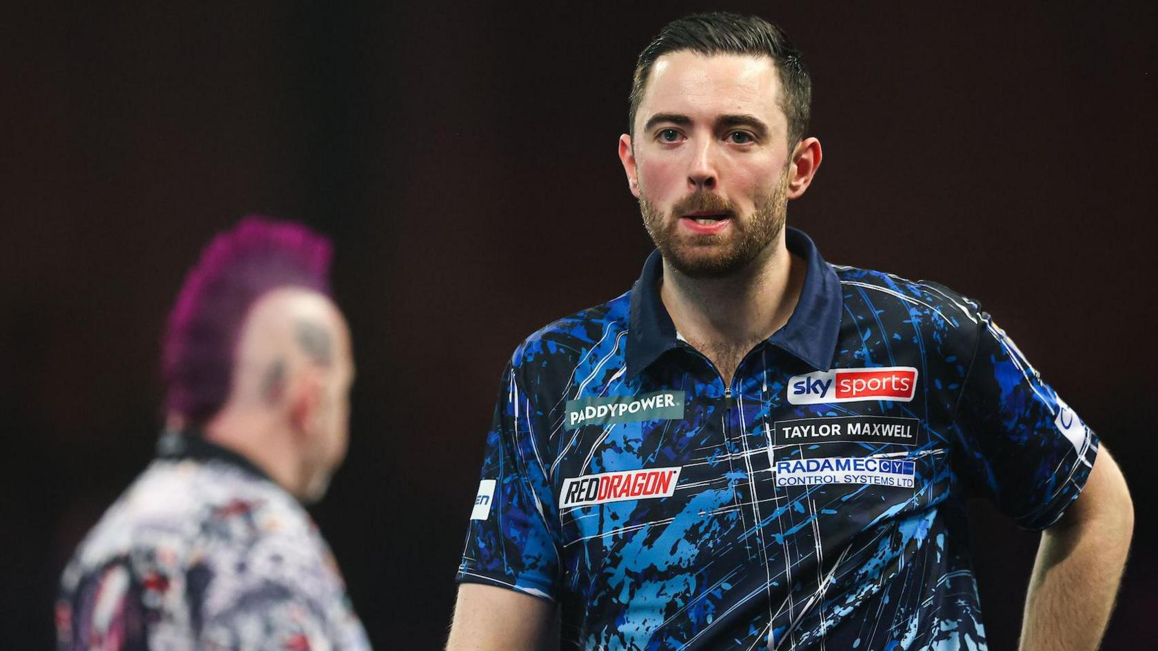 Luke Humphries walks off the stage after being beaten by Peter Wright in the PDC World Darts Championship fourth round