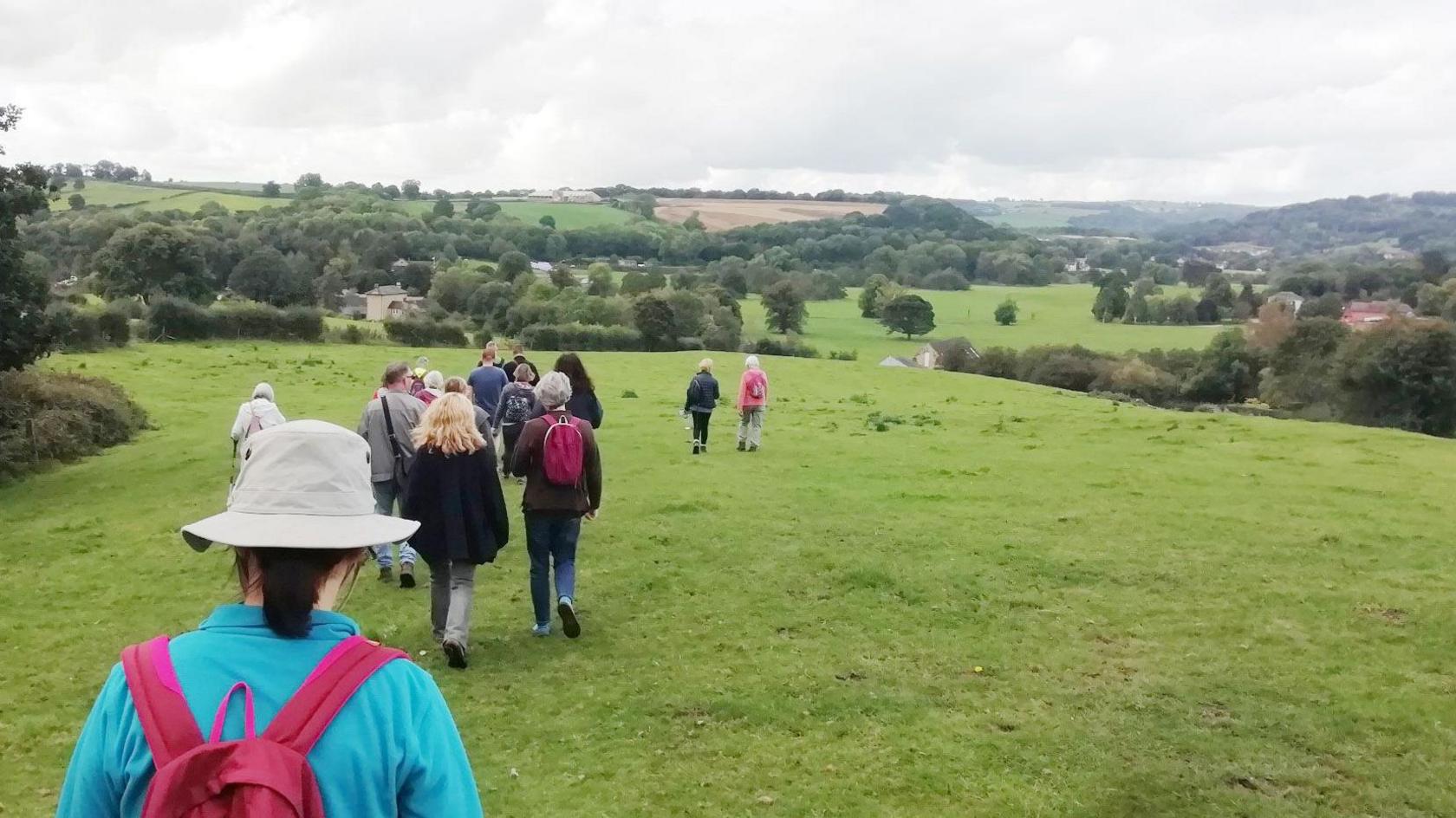 People walking in a field in Amber Valley