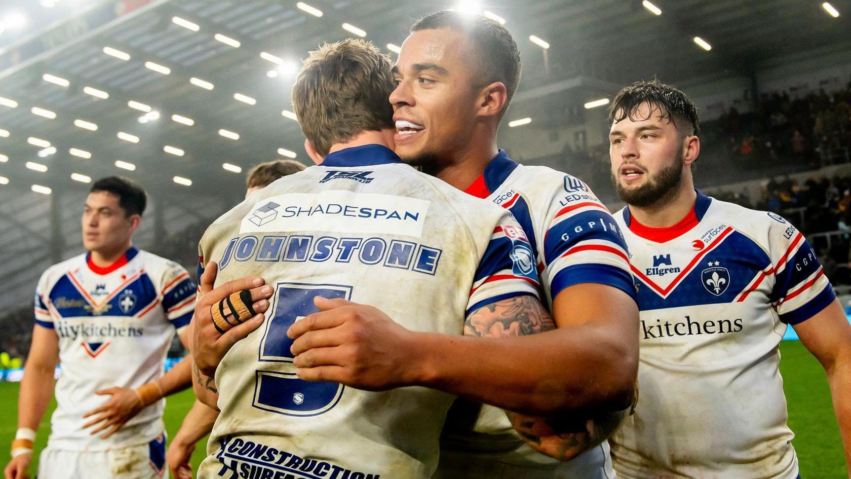 Wakefield players Corey Hall and Tom Johnstone embrace after the hooter sounded to confirm victory over Leeds in the Super League opener