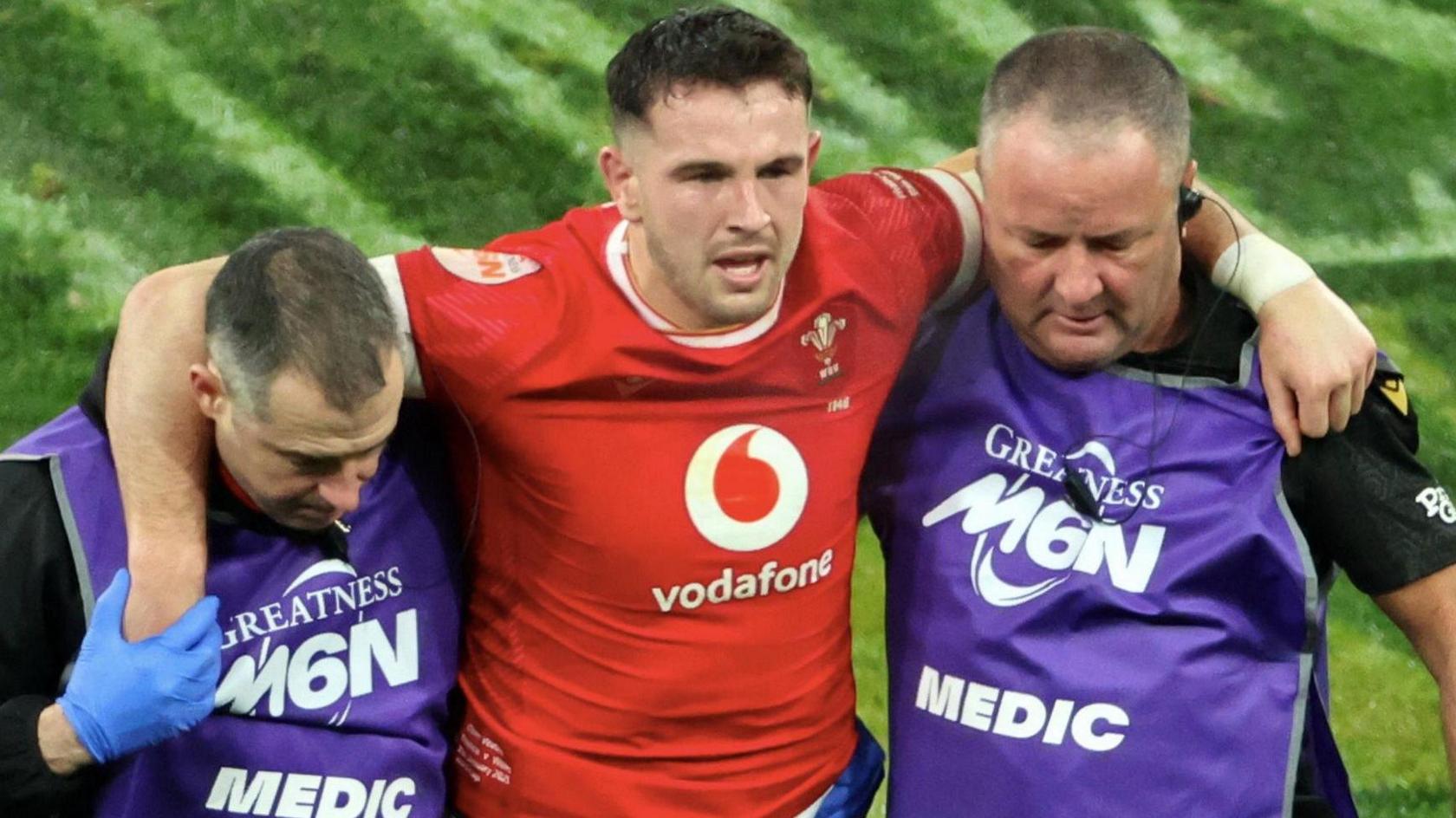 Owen Watkin is helped off against France in the 2025 Six Nations