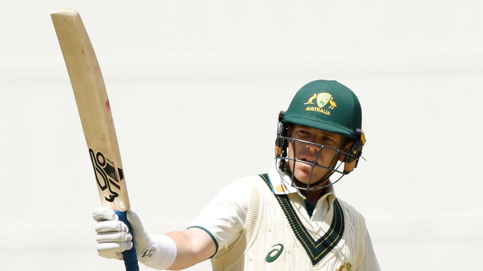 Marcus Harris raises his bat after scoring 74 for Australia A against India A this winter