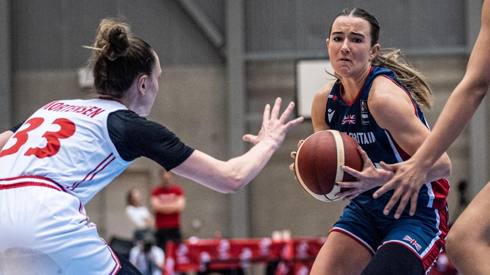 A GB player holds the basketball during the game against Denmark 