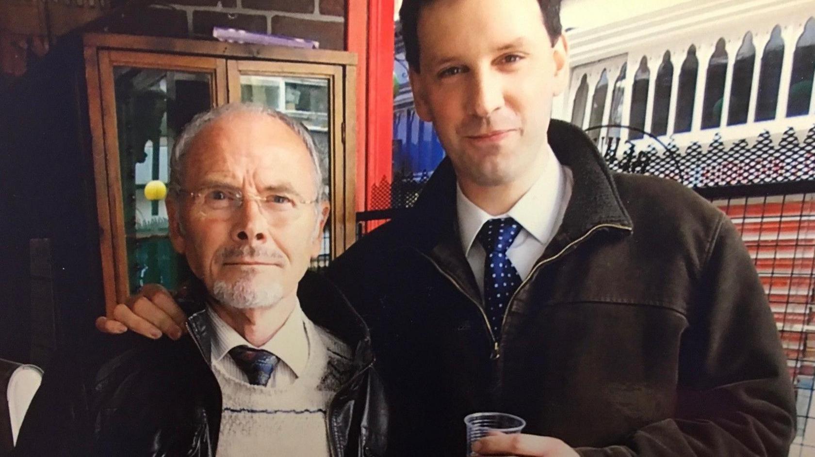 An old picture, date unknown, showing Phil Hutchinson, as a young man, with his arm around his mentor George Pawlett. Both men are wearing a shirt and tie.