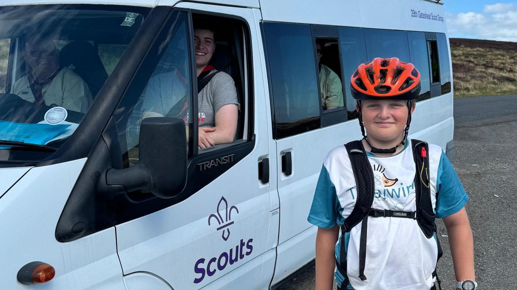 Harry stands with a scout van 