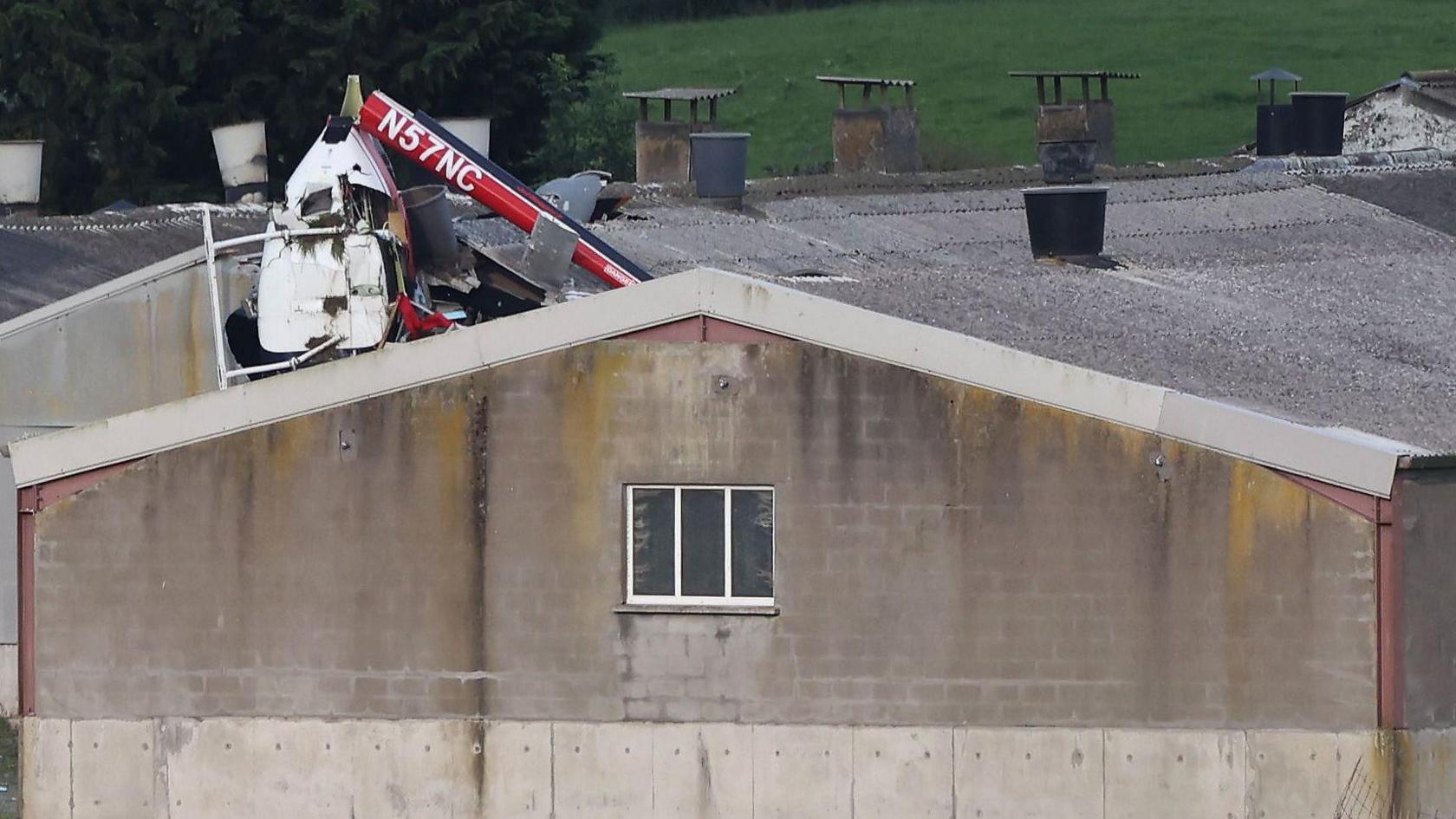 A helicopter crashed into the roof of a farm building 