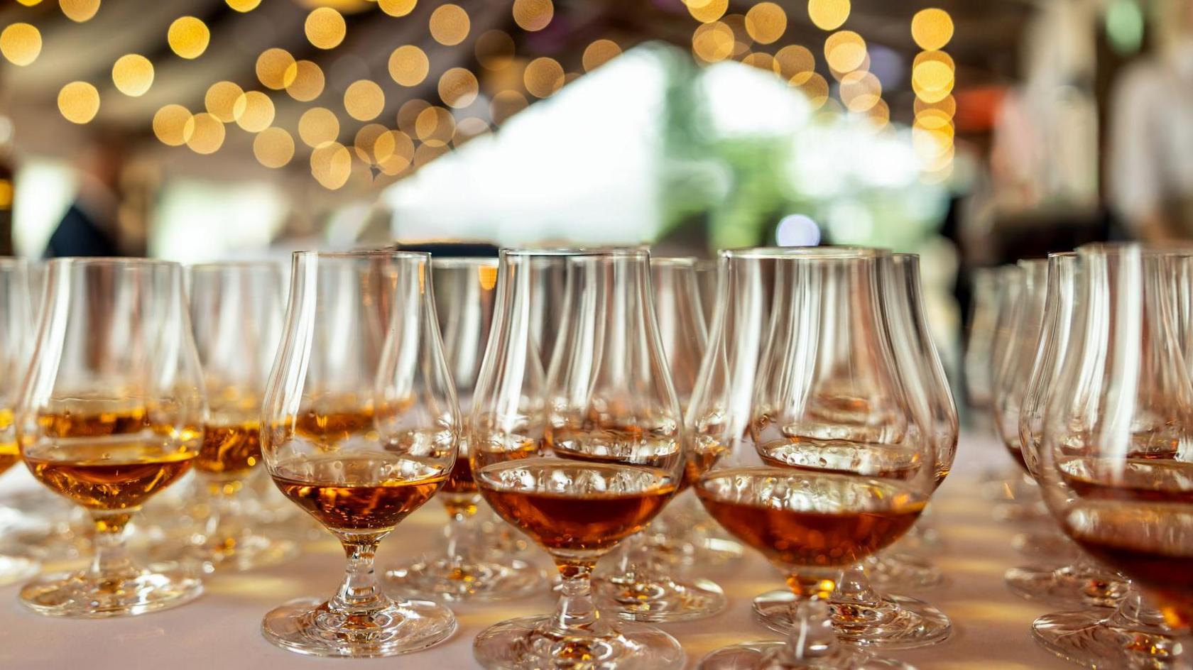 Glasses with brandy and other spirits in a venue with lights