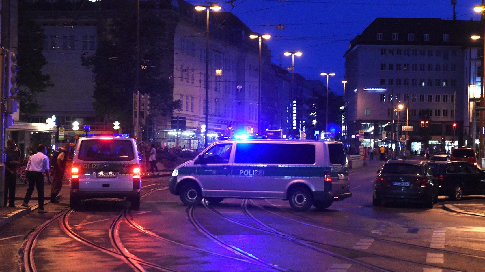 Policemen and police vehicles standing standing at the central station in Munich, Germany, 22 July 2016.