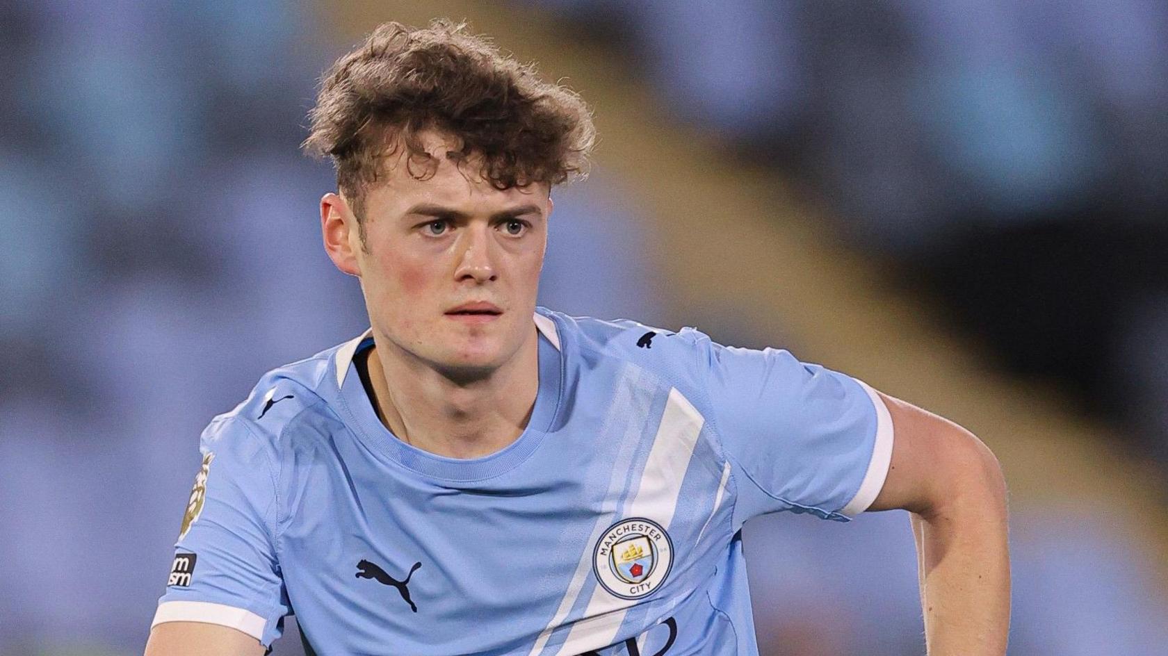 Matty Warhurst in a blue Manchester City jersey during a match.