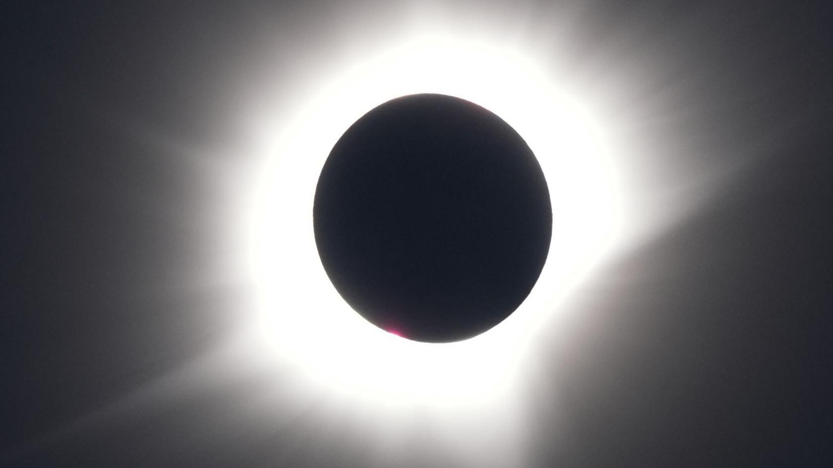 A view shows the sun almost entirely obscured by the moon as seen from a cruise ship off Greenland
