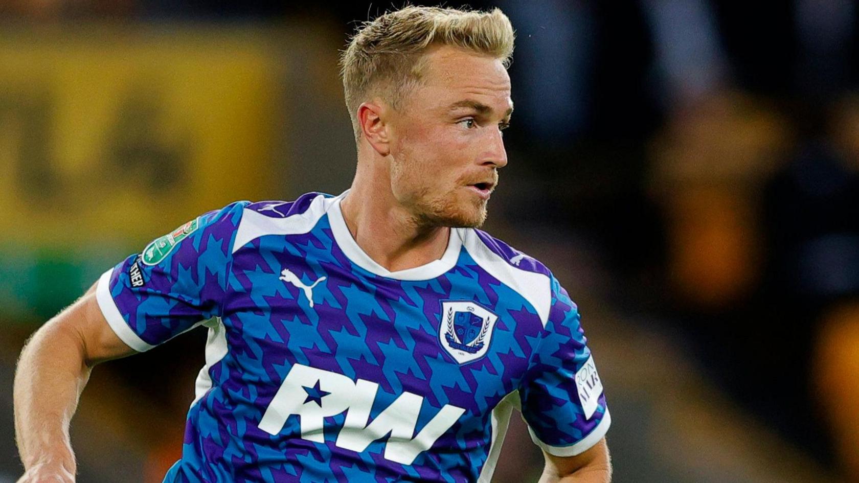 Kyle Dempsey wearing Port Vale's blue away kit during the EFL Cup game against Wolves