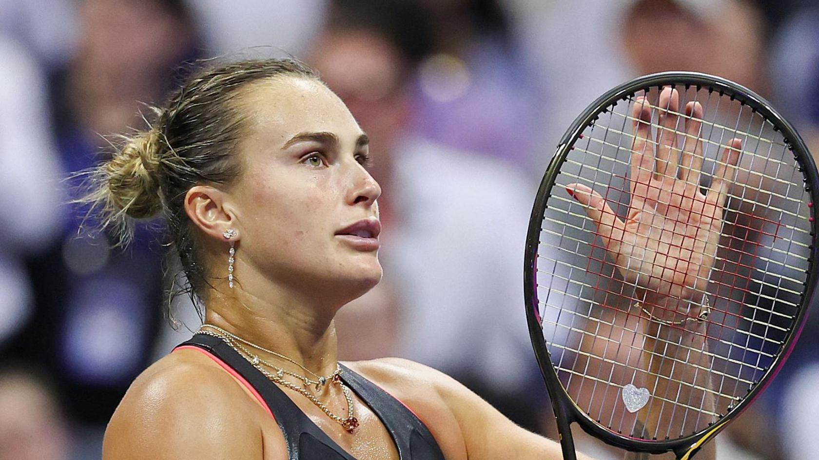 Aryna Sabalenka claps her racquet at the 2025 US Open