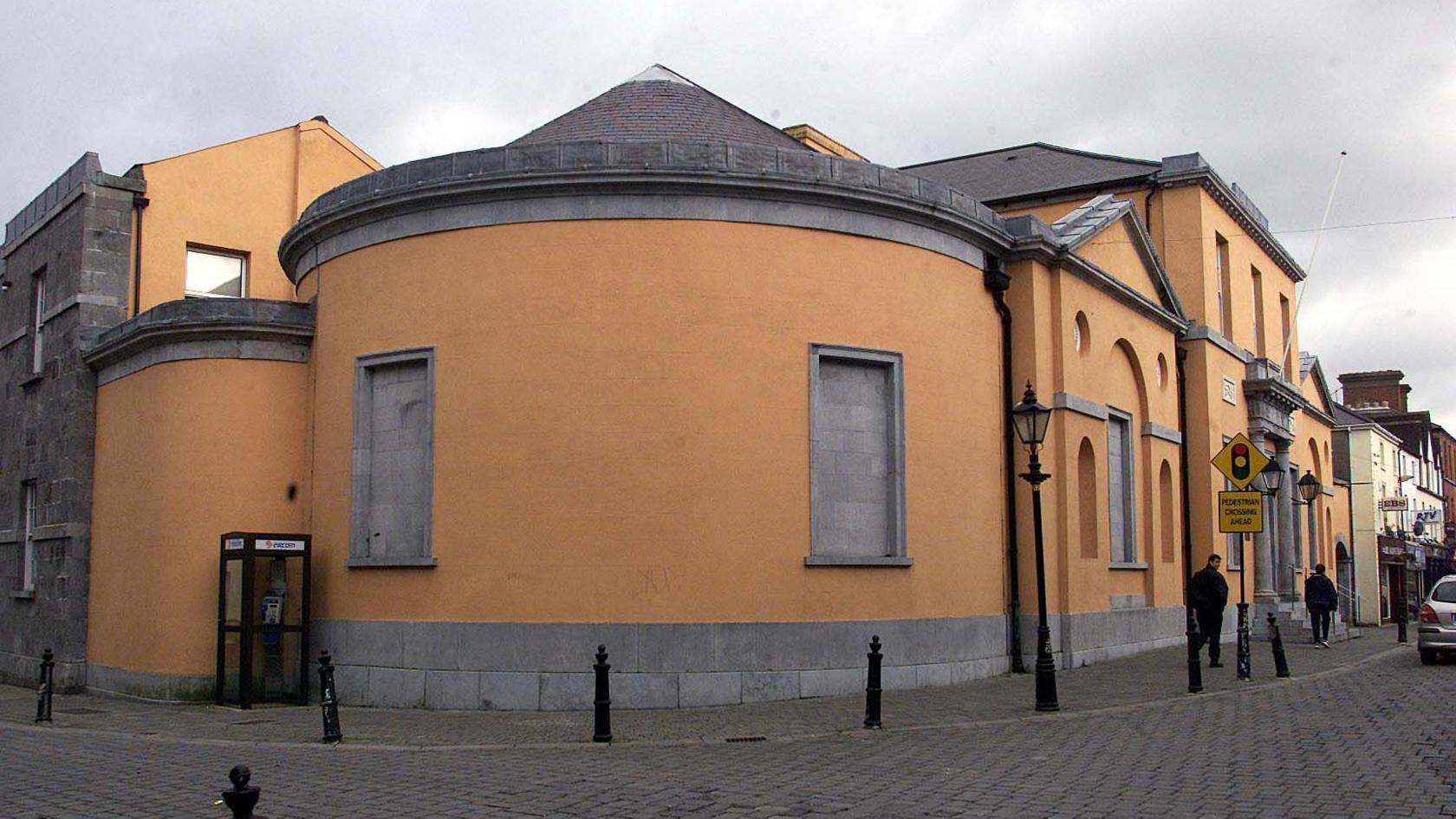 Orange curved building with grey roof, Portlaoise courthouse