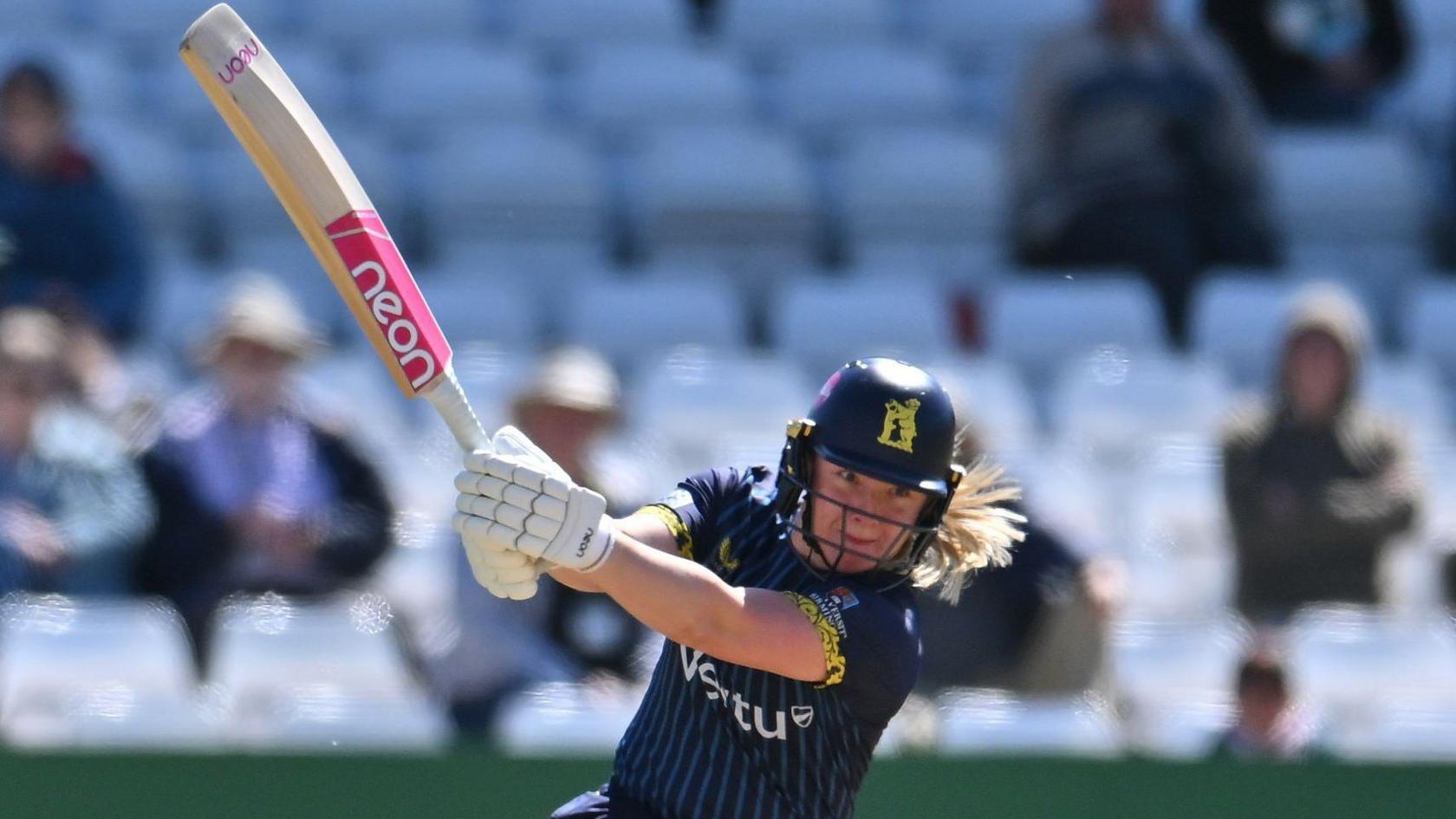 Left-hander Charis Pavely playing a powerful stroke for Warwickshire