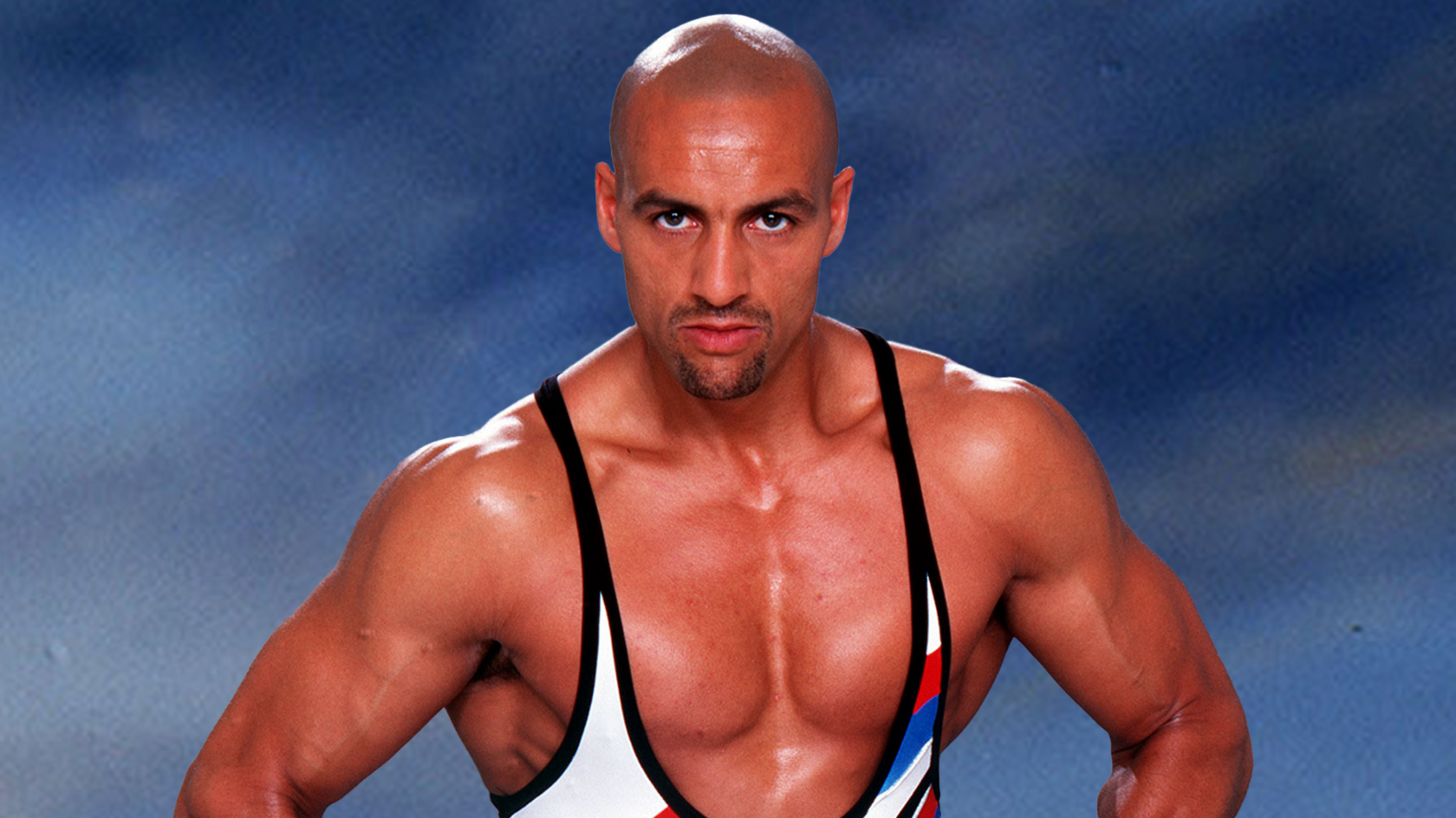 Daz Crawford in his days as a Gladiator. He's very muscular and wearing his white, black, blue and red singlet.