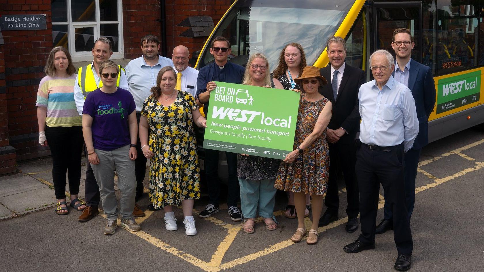 A group of people, including MPs Dan Norris and Darren Jones, stand in front of a new bus