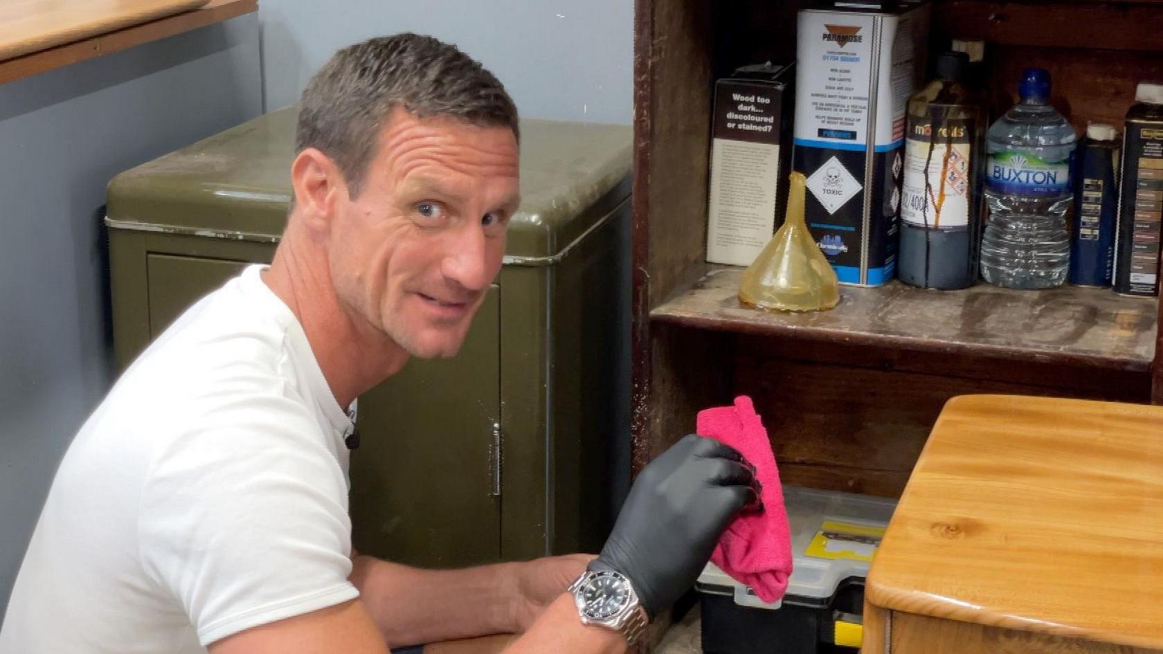 Steve varnishing furniture with a cloth using his own varnish mix