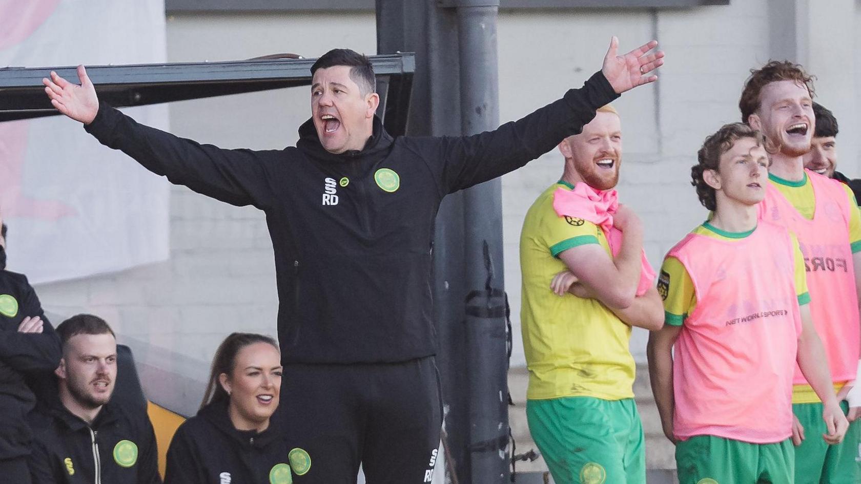 Caernarfon manager Richard Davies with his arms outstretched on the touchline