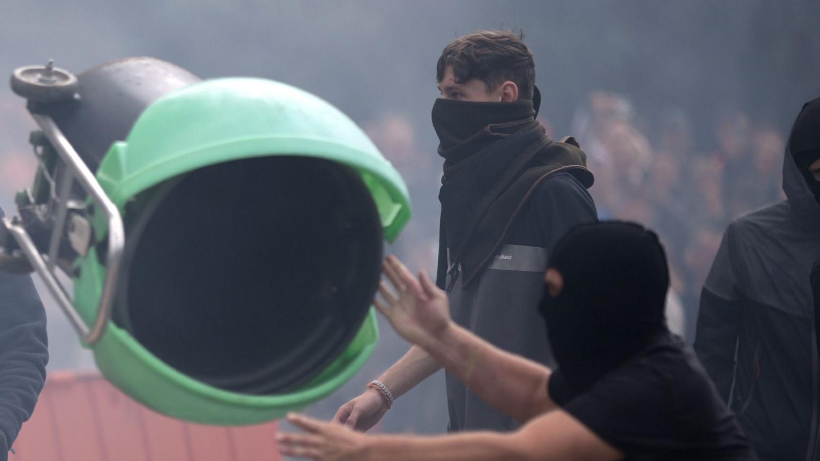 A person throwing a bin