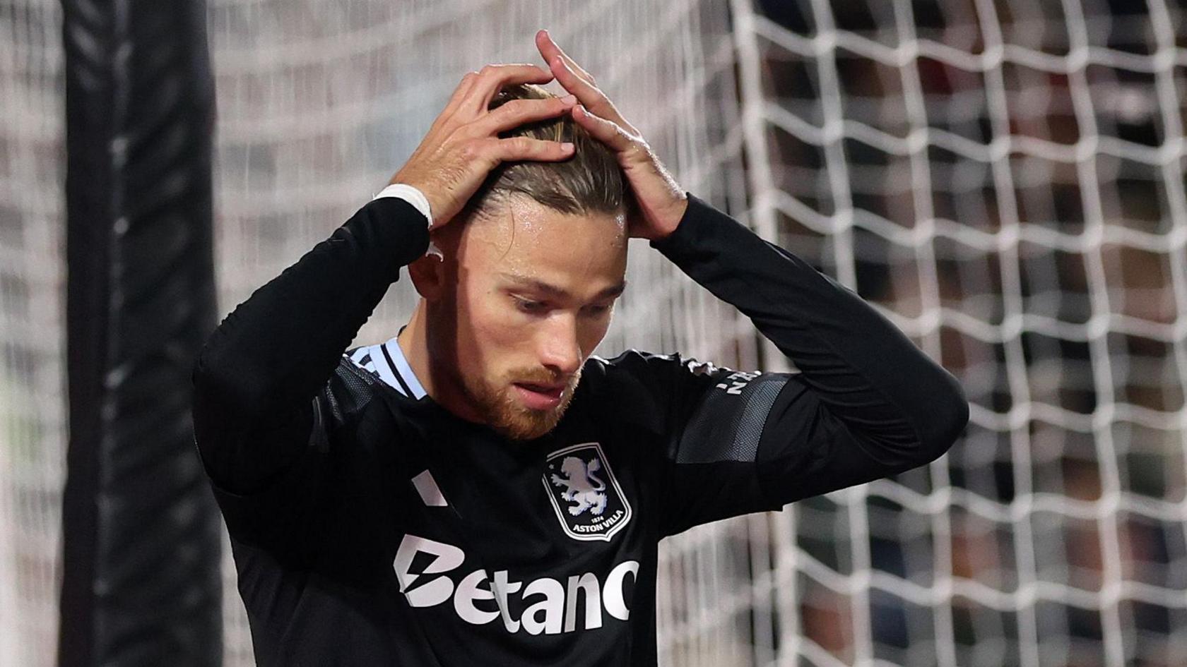 Matty Cash reacts after save