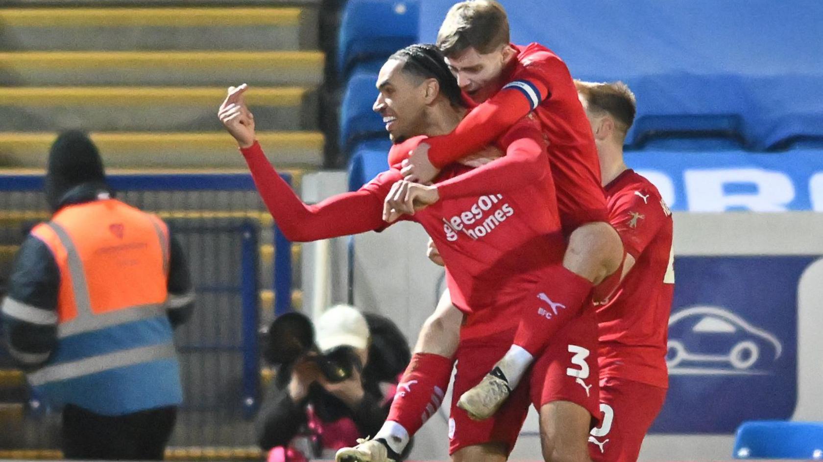 Jon Russell carried a team-mate on his back after scoring for Barnsley in their win at Peterborough